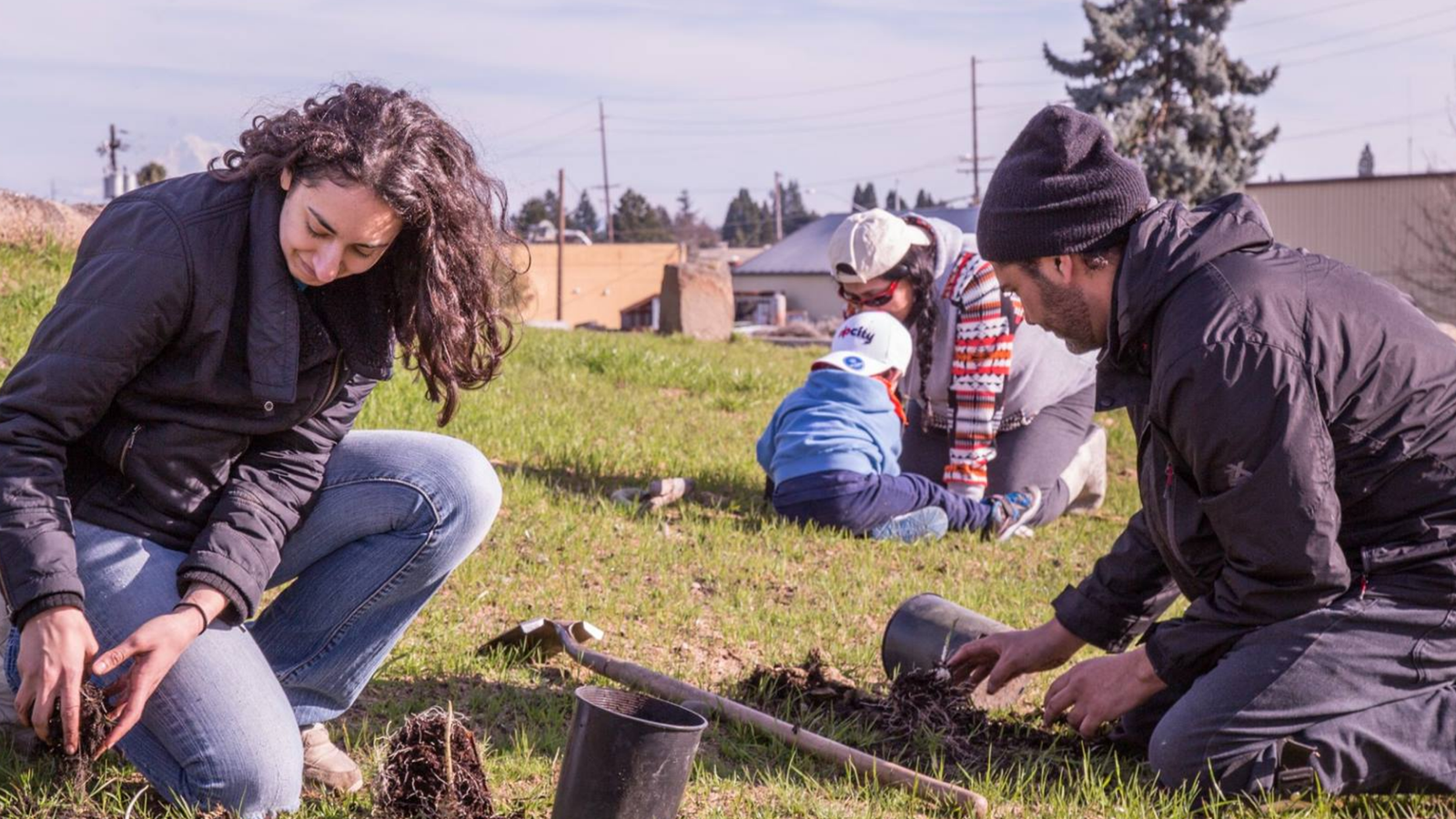 Volunteers planting seeds in a field