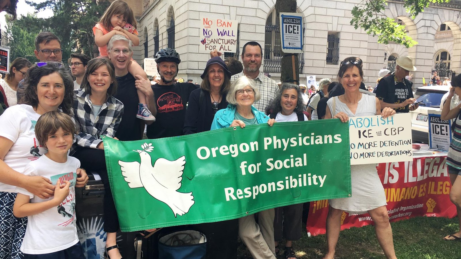 Members of Oregon PSR at a public march with a banner