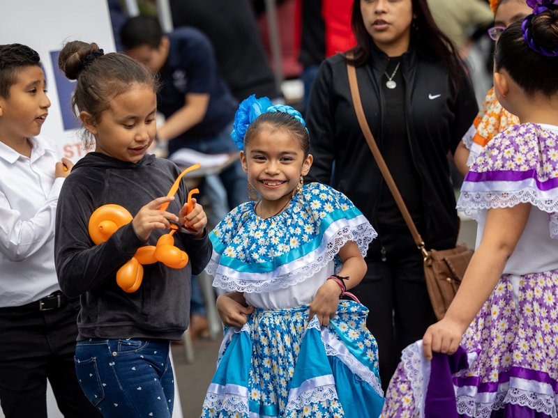 Children in colorful costumes at a Dia de los niños festival