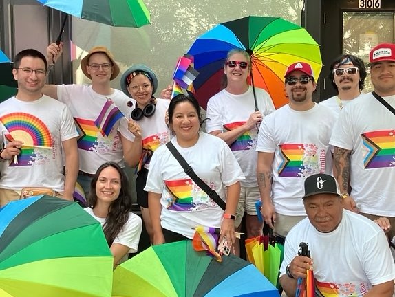 Group portrait of people in rainbow pride t-shirts