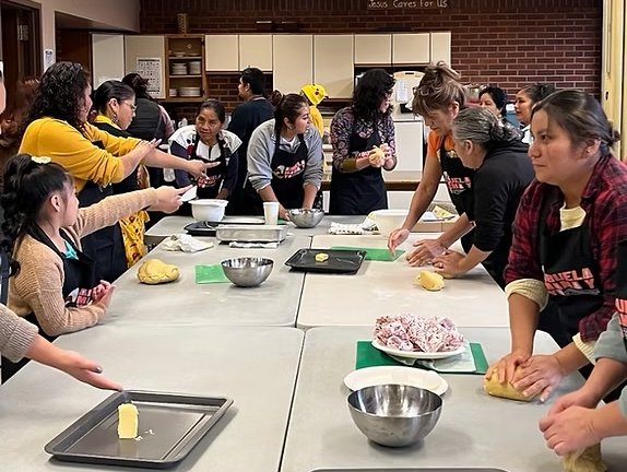 Group of people cooking, as in a cooking class