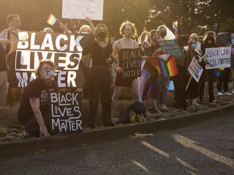 Rallygoers with many signs reading “Black Lives Matter”