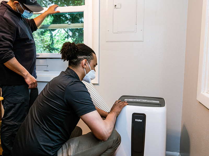 City of Portland workers installing a cooling unit