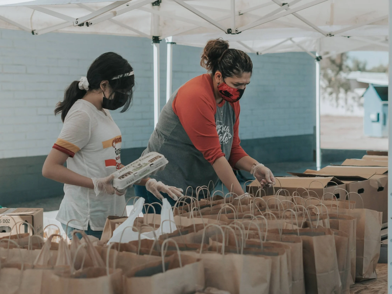 Volunteers packing food in bags for a CSA food program