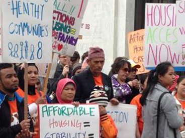 Signs at a Housing Justice rally