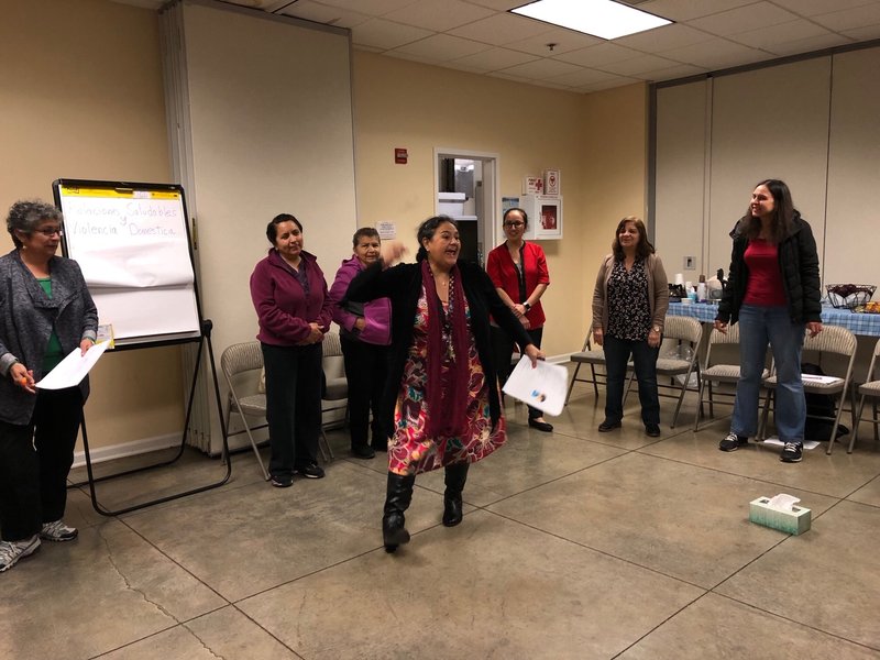 Participants at a group meeting for Raíces de Bienestar