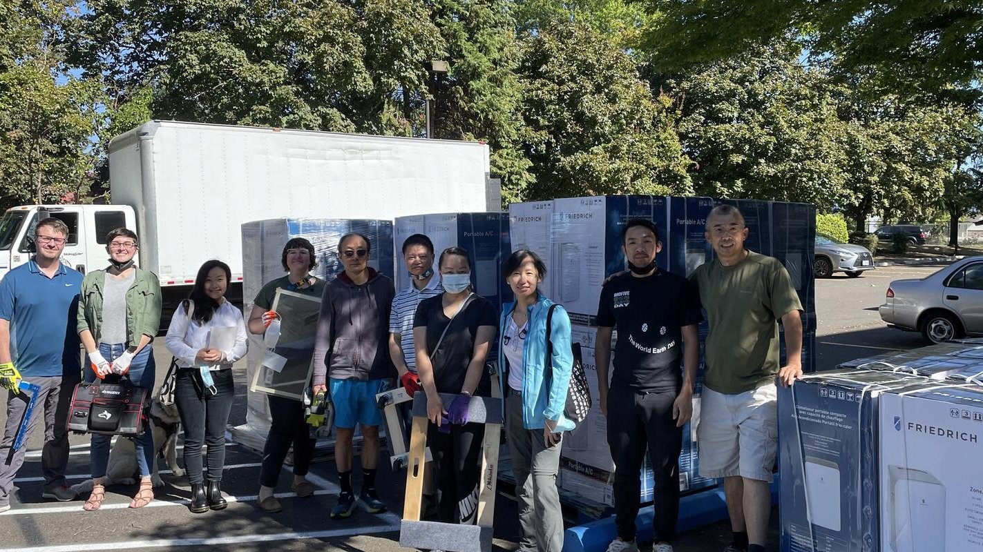 Portland COAD employees with AC and cooling units outdoors at a cooling center