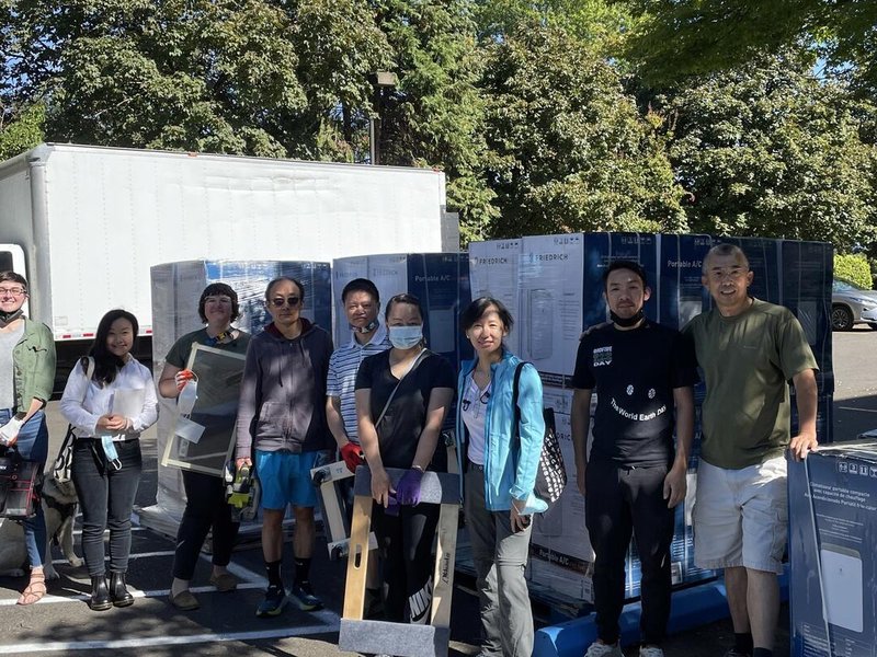 Portland COAD employees with AC and cooling units outdoors at a cooling center