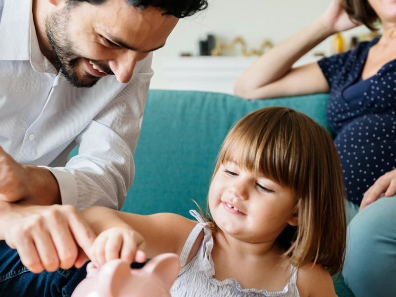 A young family with a piggy bank