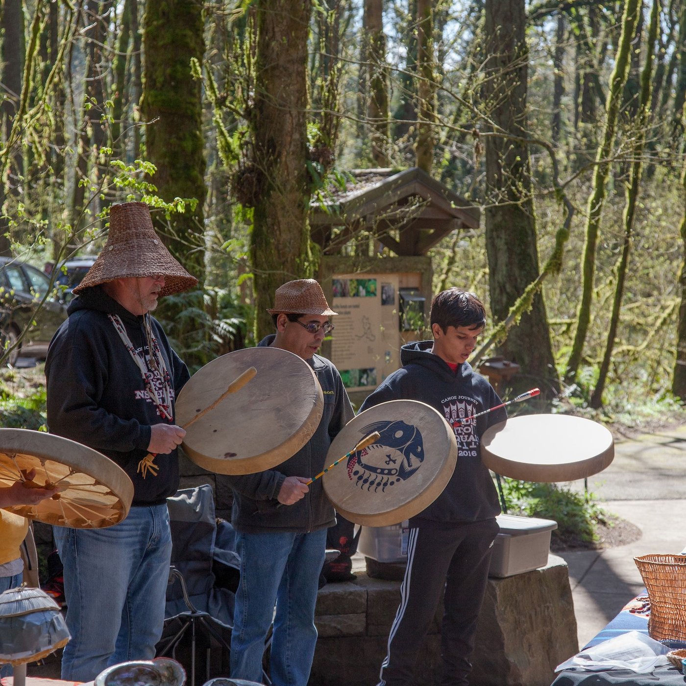 group of Native drummers at a public performance in a forest