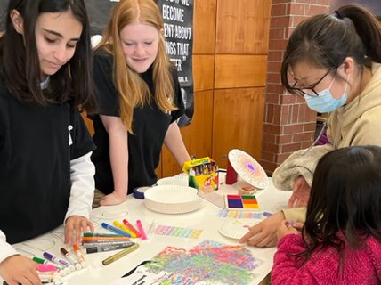 Young people making signs or art in a community space